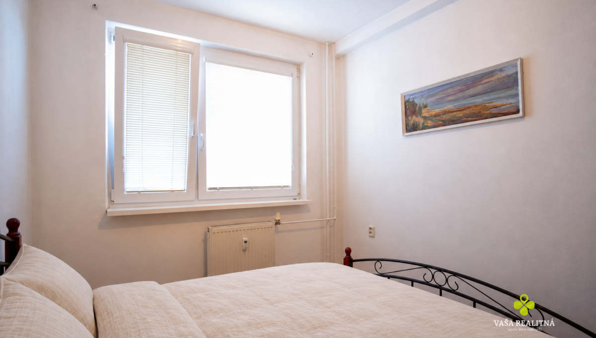 Warm Beige Bedding on Curved Metal Bed